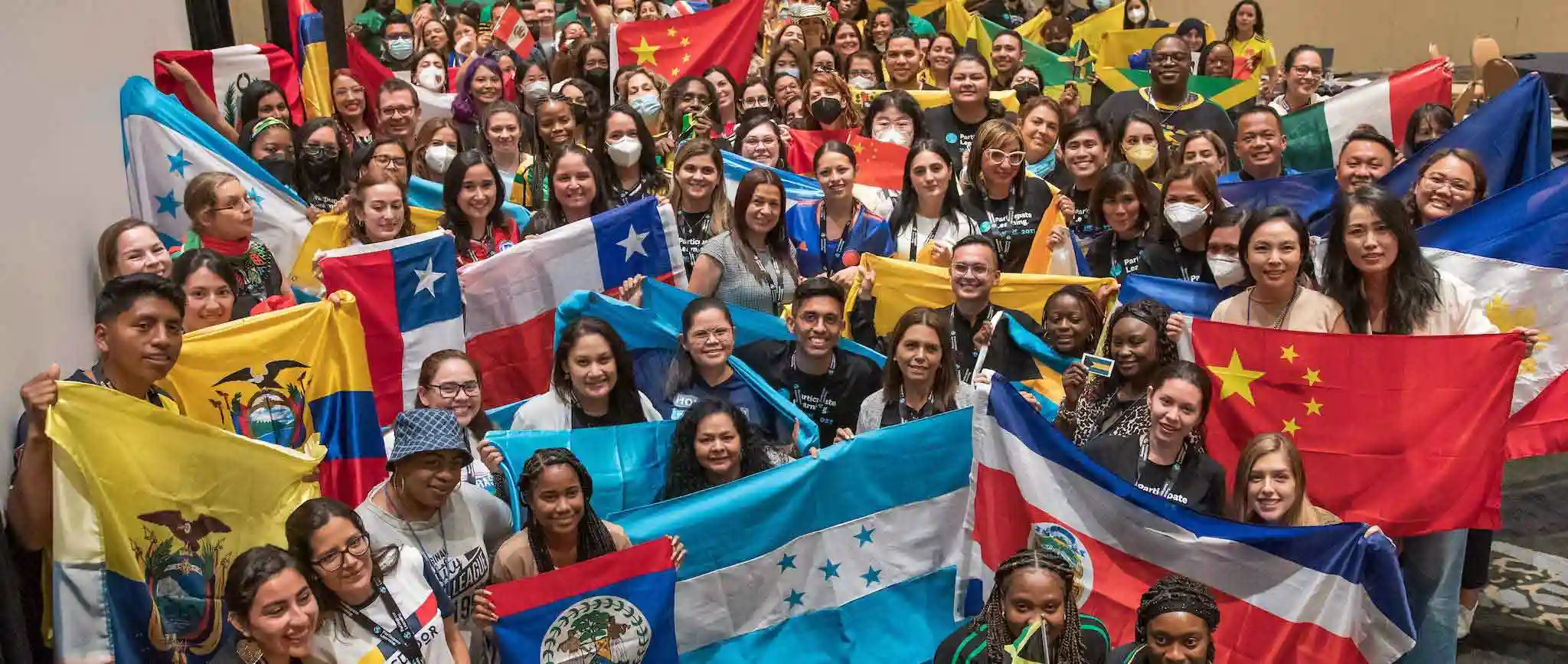 International educators holding their home country’s flag after arriving to teach in the usa