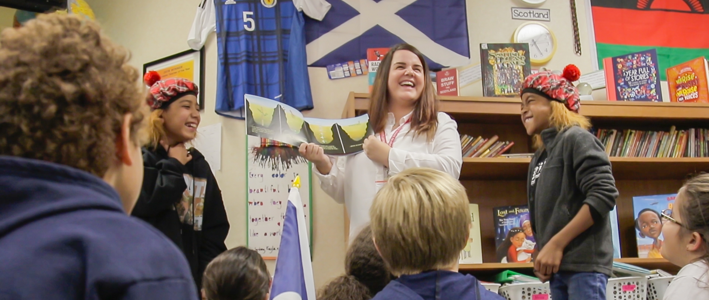 A teacher reading a book about global education to a class of elementary school students