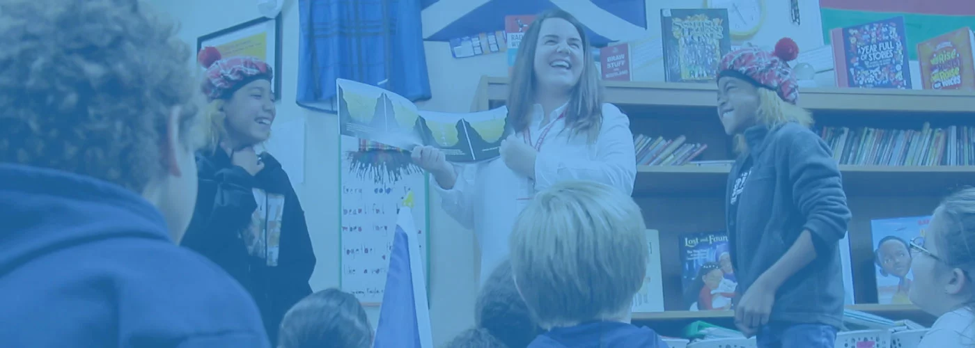 A teacher reading a book about global education to a class of elementary school students