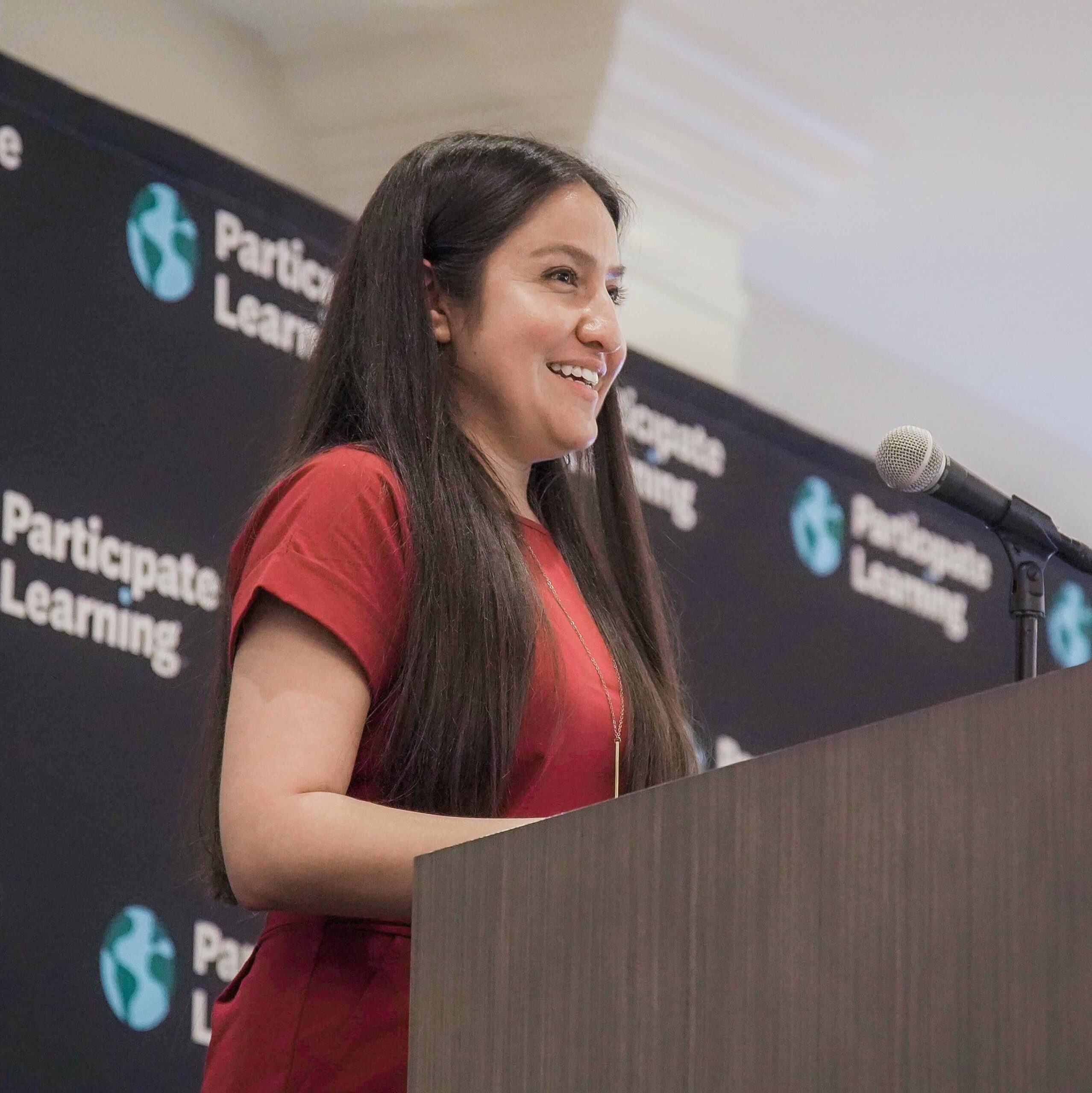 Ambassador Teacher displaying skills gained through teacher development program by speaking at a graduation ceremony