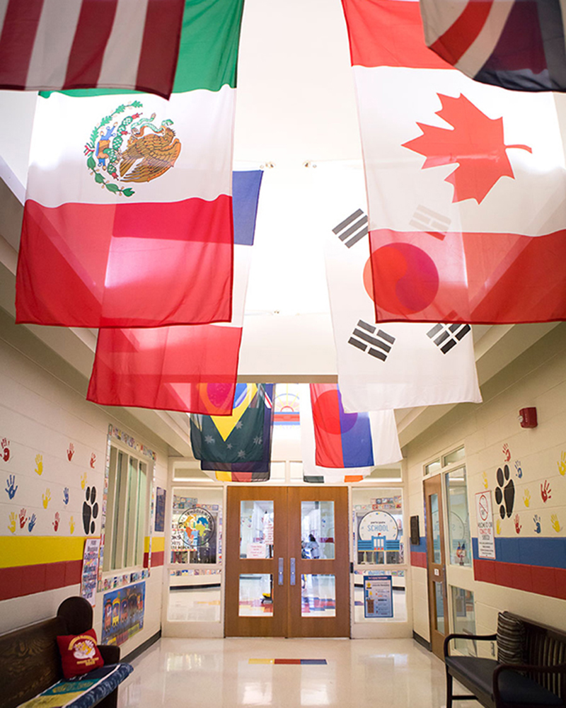 A school decorated with flags from different countries to provide support for international teachers in the USA