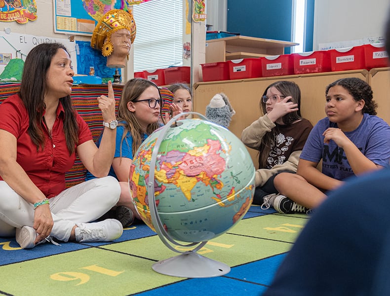 Teacher and students study global issues.