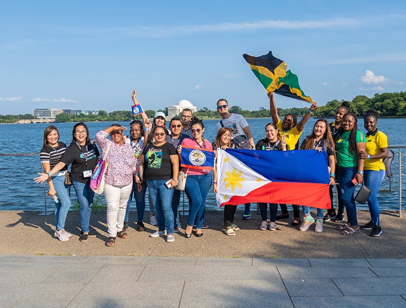 Global Leaders at Washington D.C. monument holding Jamaican and Philippine flags