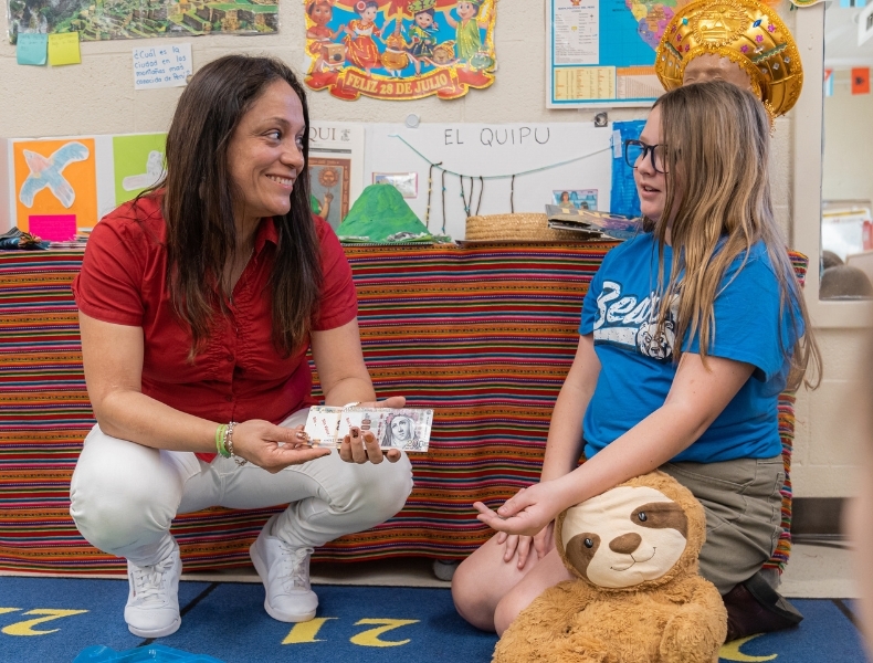 A dual language immersion educator teaching a student.