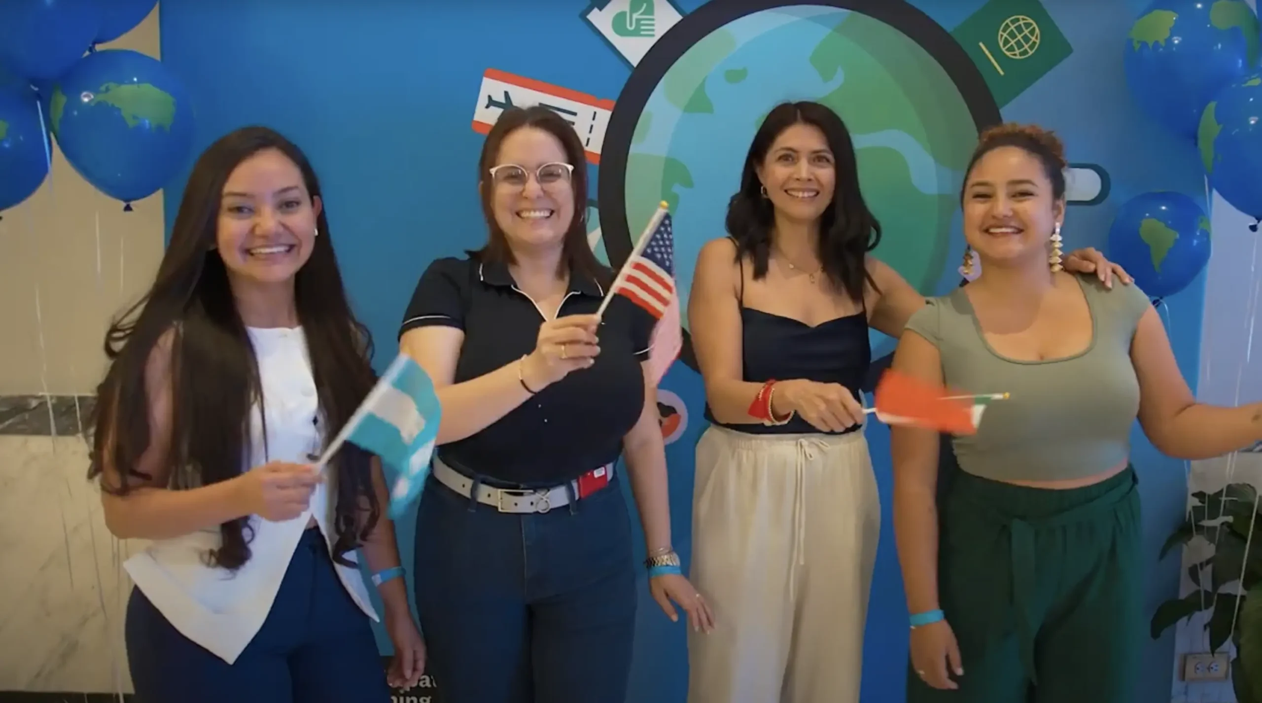 International teacher leads a diverse group of young students in a U.S. classroom, engaging them with a Spanish counting lesson on a screen. Promotes teaching abroad, bilingual education, and professional growth through teaching in the U.S.