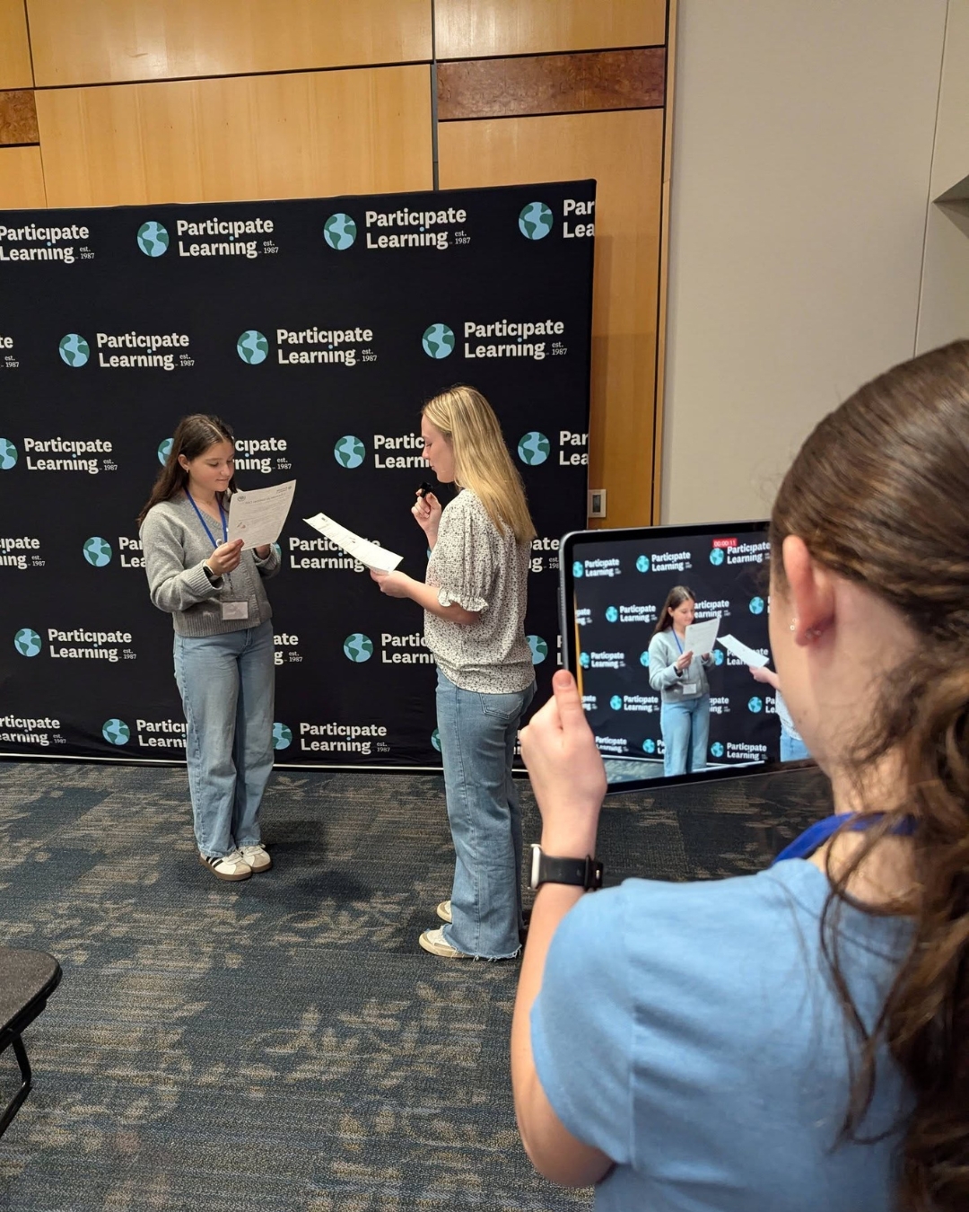 A group of three DL middle schools students recording a video during CAD