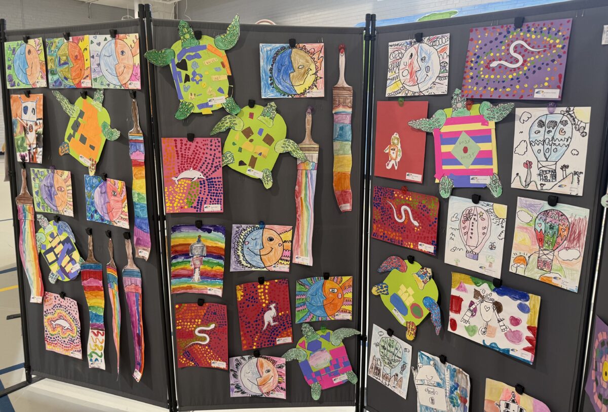 Display of student artwork featuring sea turtles, hot air balloons, and global-themed designs, showcasing creativity and global learning connections.